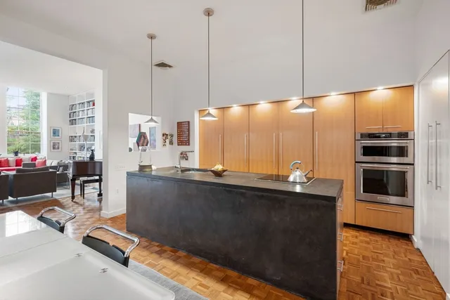 a kitchen with stainless steel appliances a counter top space a sink a refrigerator and window