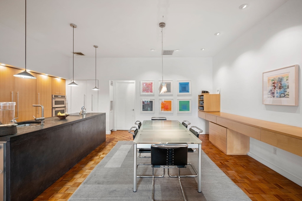 72 Mt Vernon Street, Unit 2A Boston, MA 02108 - Photo 12 of 25 a kitchen with stainless steel appliances granite countertop a sink a stove and a wooden floors