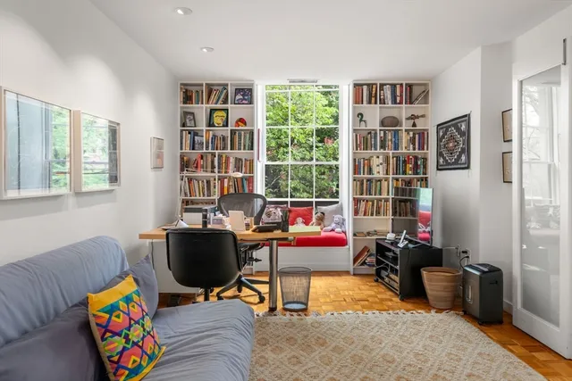 a living room with furniture and a bookshelf