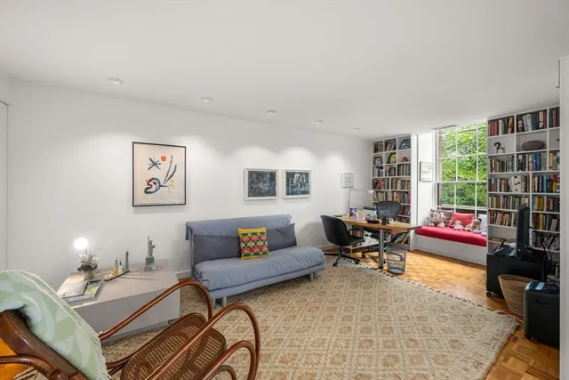 a living room with furniture and a floor to ceiling window
