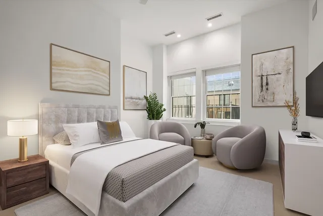 a bedroom with bed and flat screen tv