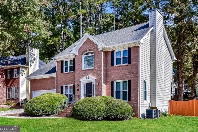a view of house with yard and green space