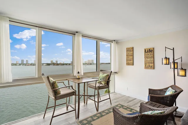 a dining room with furniture and large windows