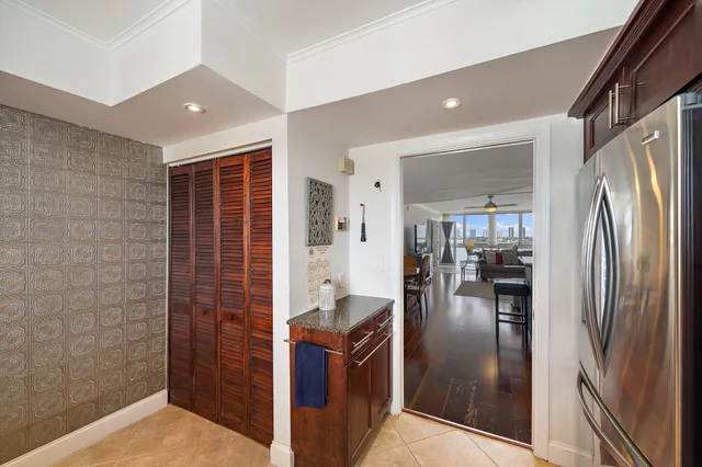 a living room with furniture a rug and a floor to ceiling window