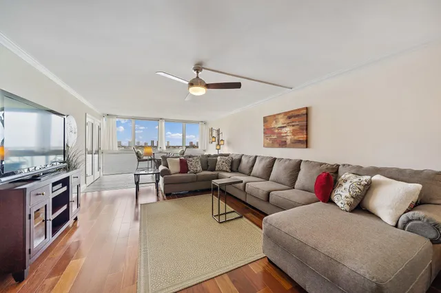 a living room with furniture kitchen view and a window