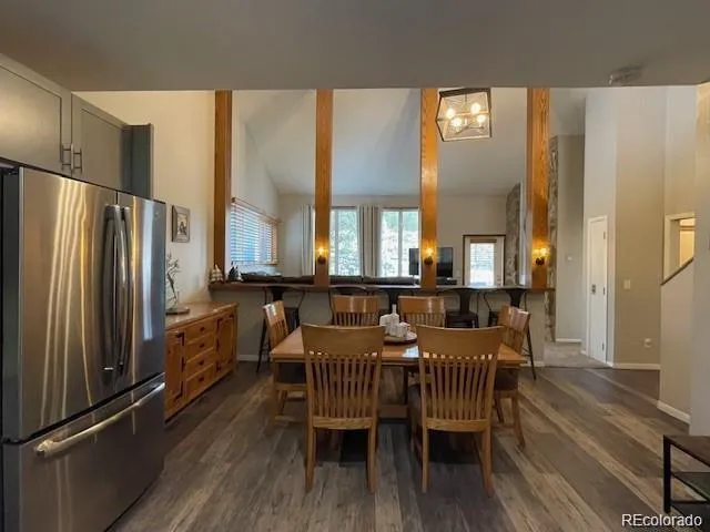 a view of a a dining room with furniture window and wooden floor