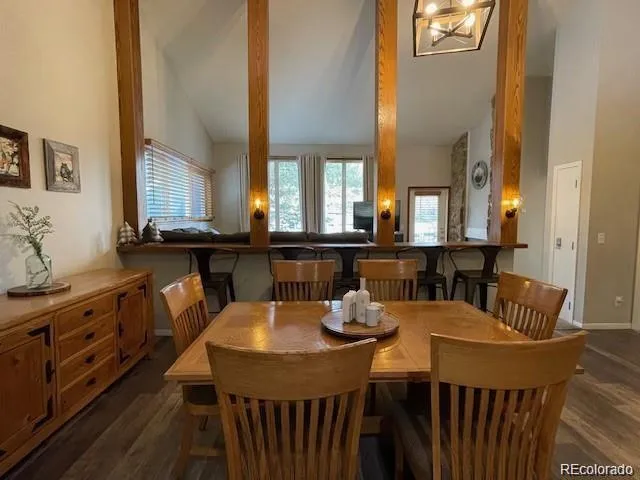a view of a a dining room with furniture window and wooden floor