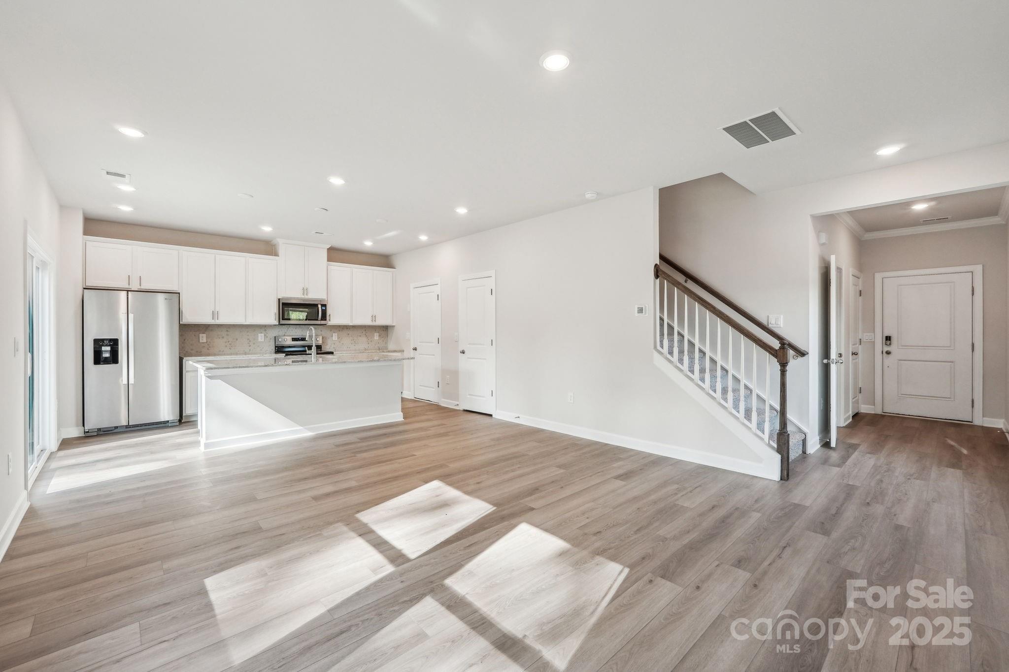 1516 31st Street Northeast Conover, NC 28613 - Photo 4 of 18 a view of empty room with wooden floor and kitchen