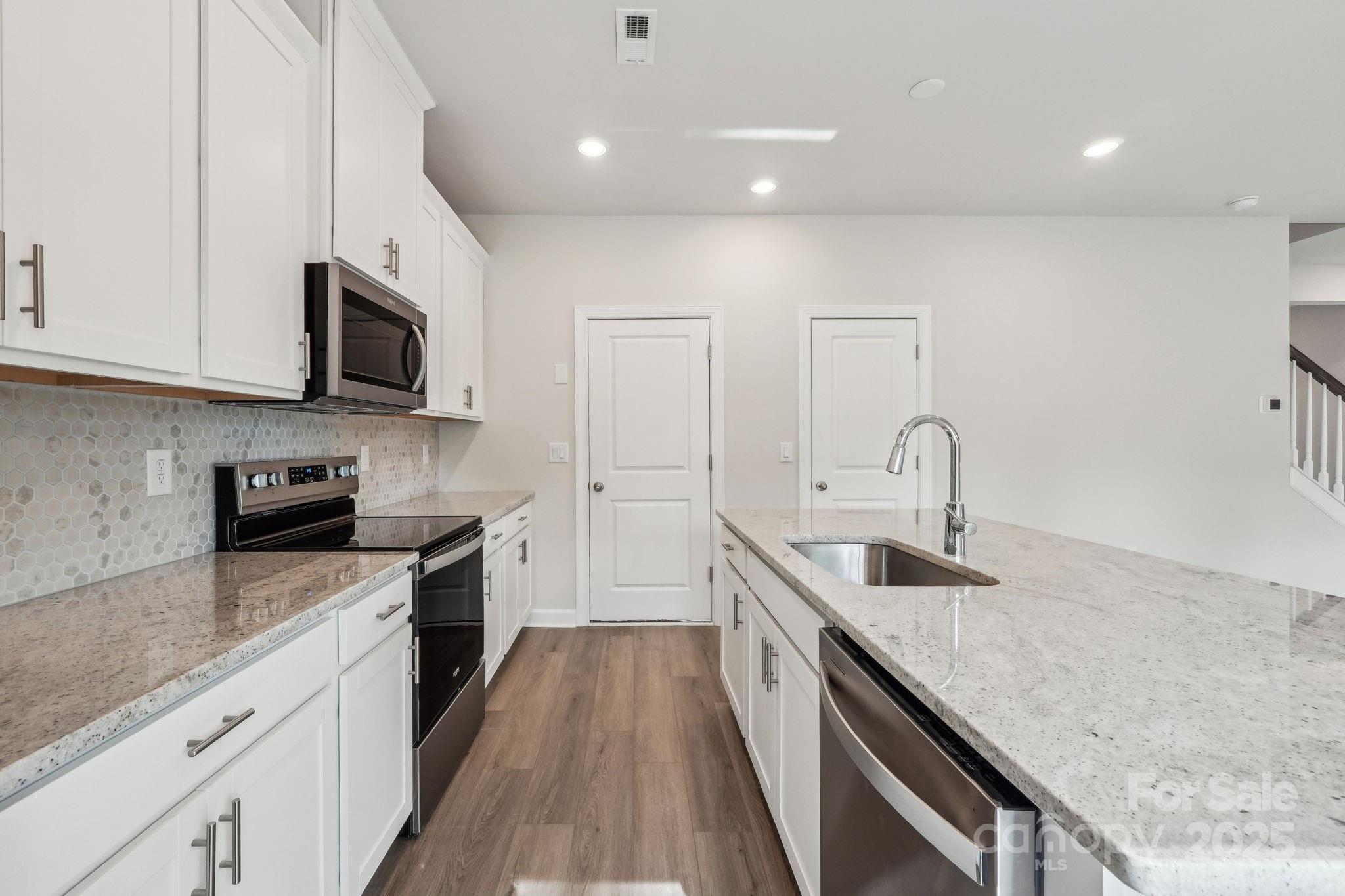 1516 31st Street Northeast Conover, NC 28613 - Photo 7 of 18 a kitchen with sink a microwave and stove