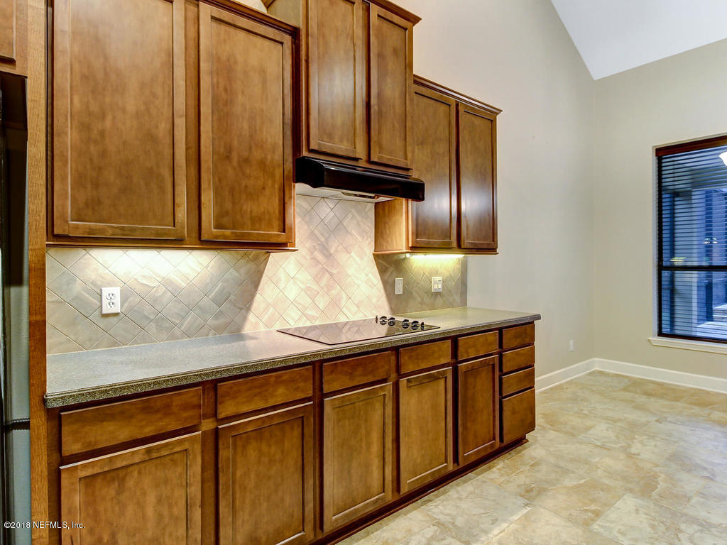 213 North Saxxon Road St. Augustine, FL 32092 - Photo 23 of 88 a kitchen with stainless steel appliances granite countertop a sink and cabinets