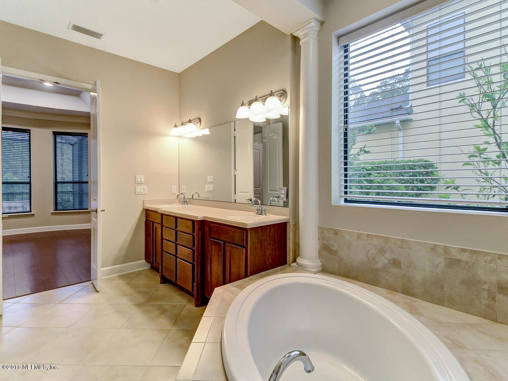 213 North Saxxon Road St. Augustine, FL 32092 - Photo 39 of 88 a spacious bathroom with a tub sink and mirror