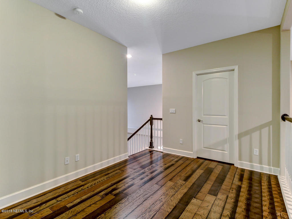 213 North Saxxon Road St. Augustine, FL 32092 - Photo 60 of 88 a view of a room with wooden floor and staircase