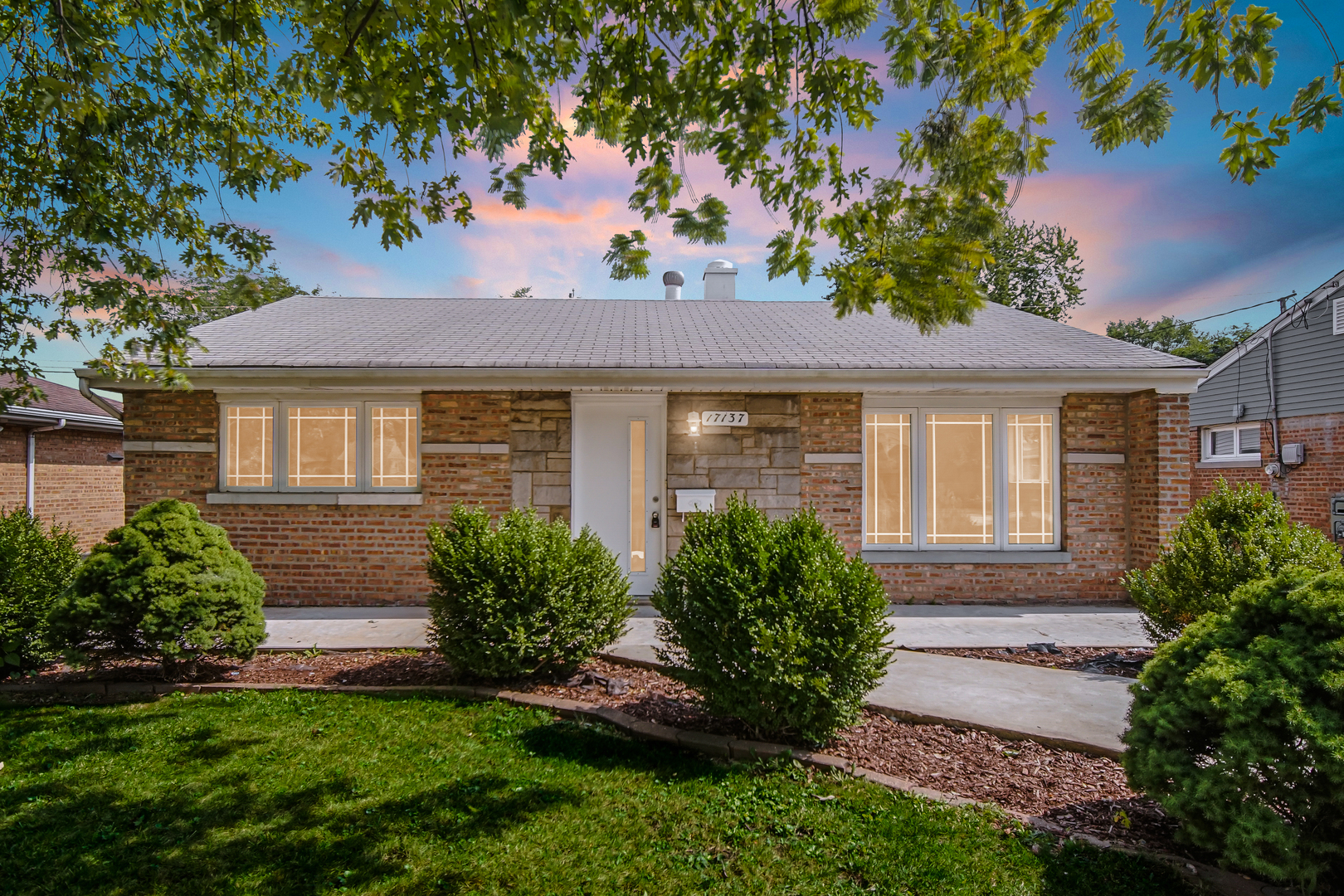 17137 Chicago Avenue Lansing, IL 60438 - Photo 1 of 11 a front view of a house with a garden