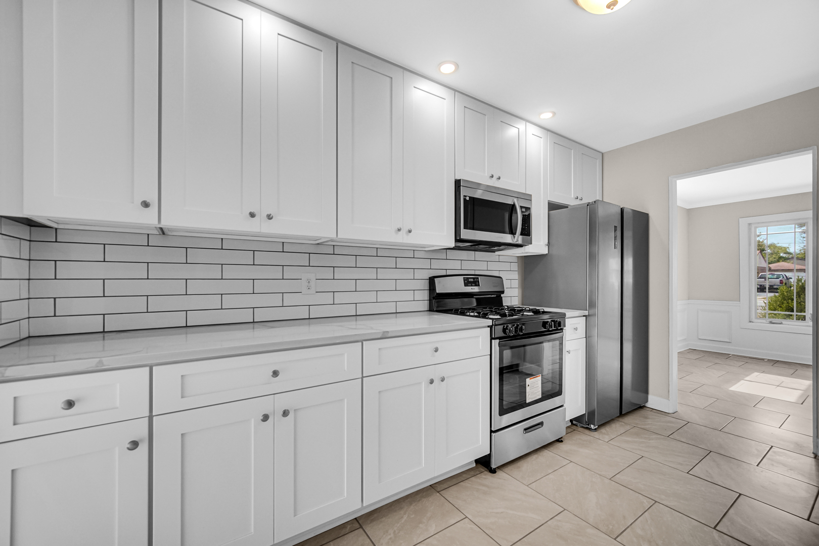 17137 Chicago Avenue Lansing, IL 60438 - Photo 4 of 11 a kitchen with white cabinets stainless steel appliances and a sink