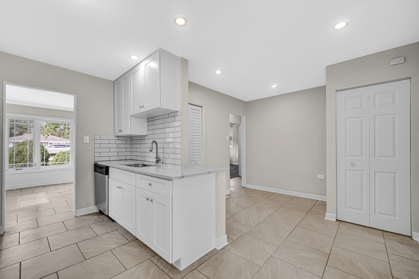 17137 Chicago Avenue Lansing, IL 60438 - Photo 5 of 11 a kitchen with granite countertop a sink and white cabinets