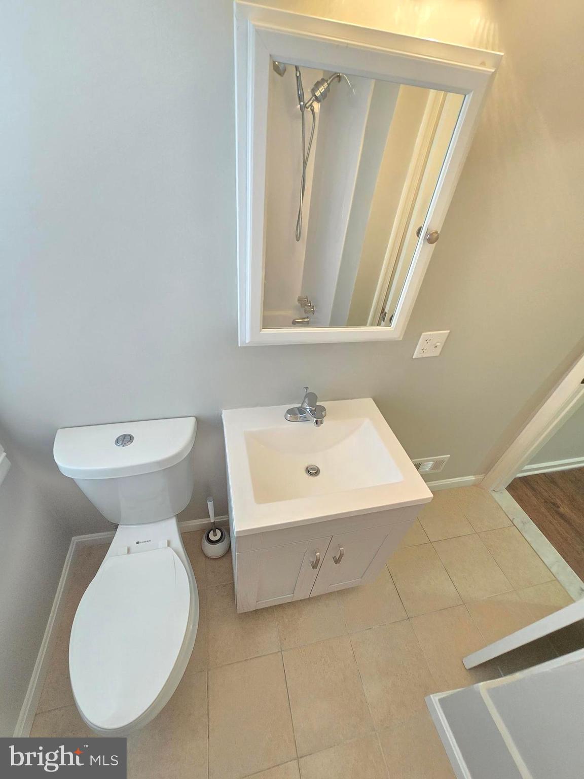 1225 Cochran Avenue Baltimore, MD 21239 - Photo 15 of 22 a bathroom with a toilet sink and mirror
