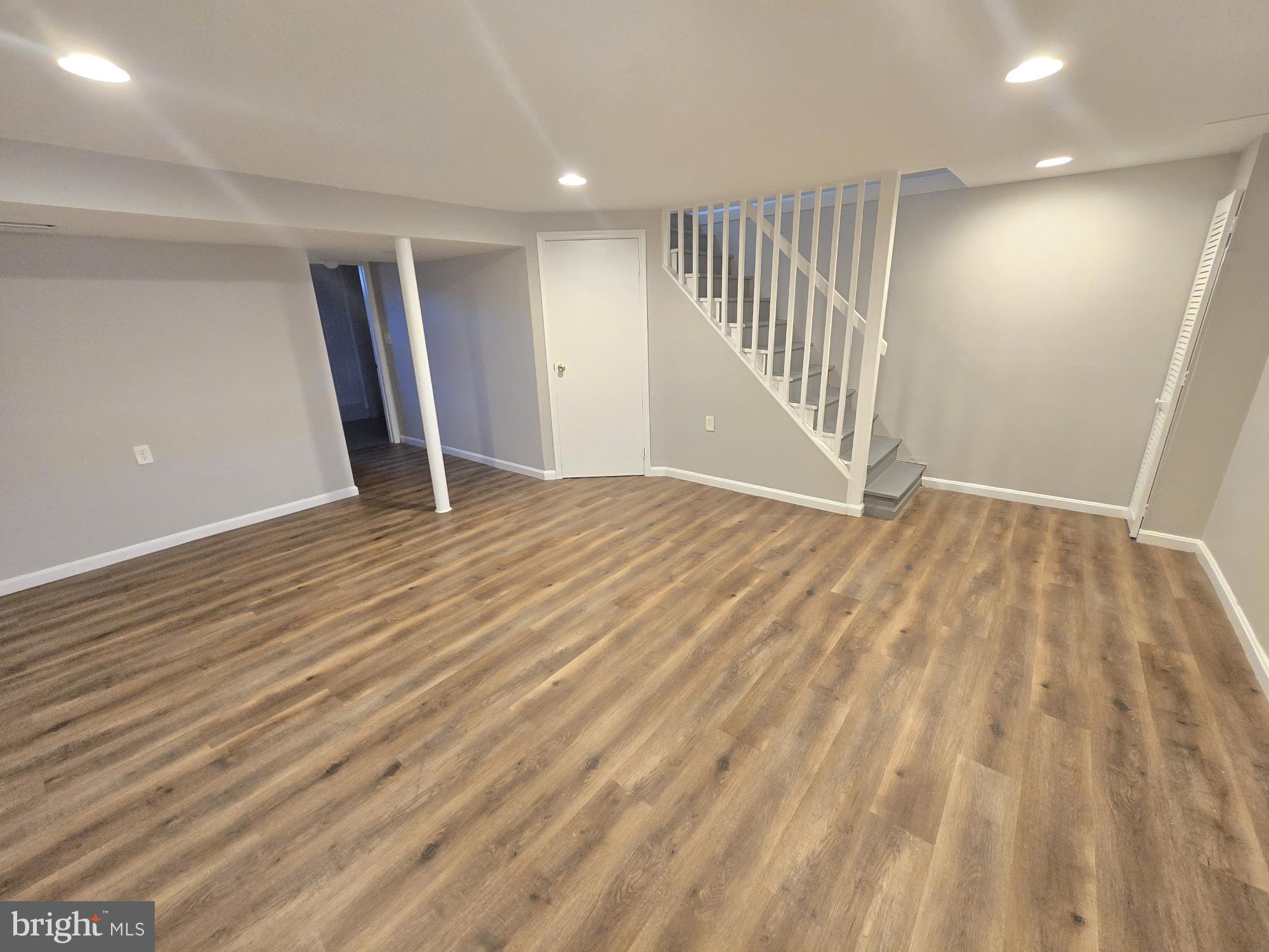 1225 Cochran Avenue Baltimore, MD 21239 - Photo 17 of 22 a view of an empty room with wooden floor