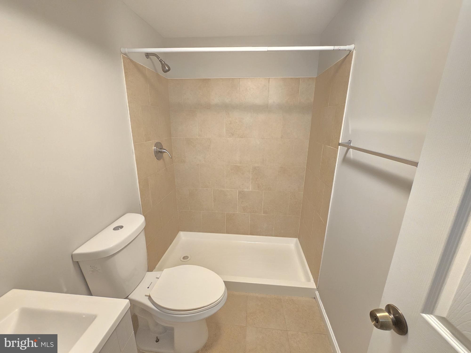 1225 Cochran Avenue Baltimore, MD 21239 - Photo 18 of 22 a bathroom with a toilet and a shower