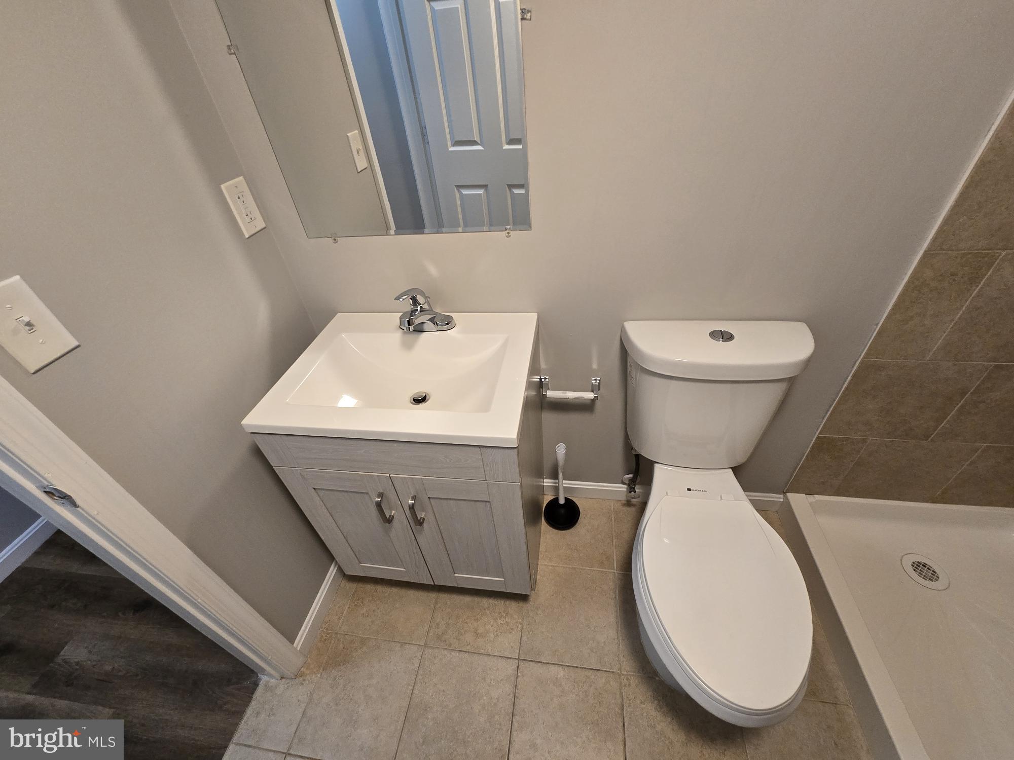 1225 Cochran Avenue Baltimore, MD 21239 - Photo 19 of 22 a bathroom with a sink and mirror with toilet