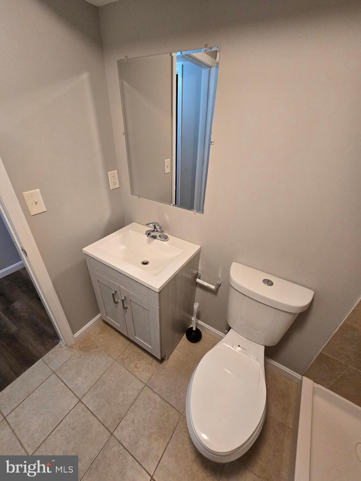 1225 Cochran Avenue Baltimore, MD 21239 - Photo 20 of 22 a bathroom with a toilet a sink and a mirror