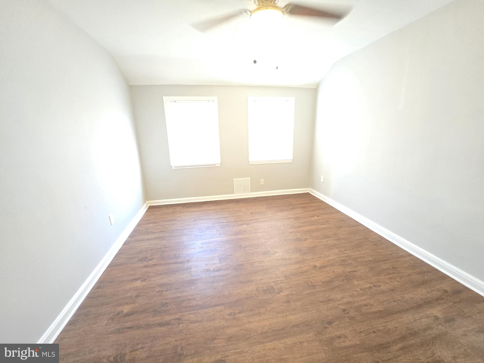 1225 Cochran Avenue Baltimore, MD 21239 - Photo 8 of 22 a view of an empty room with wooden floor