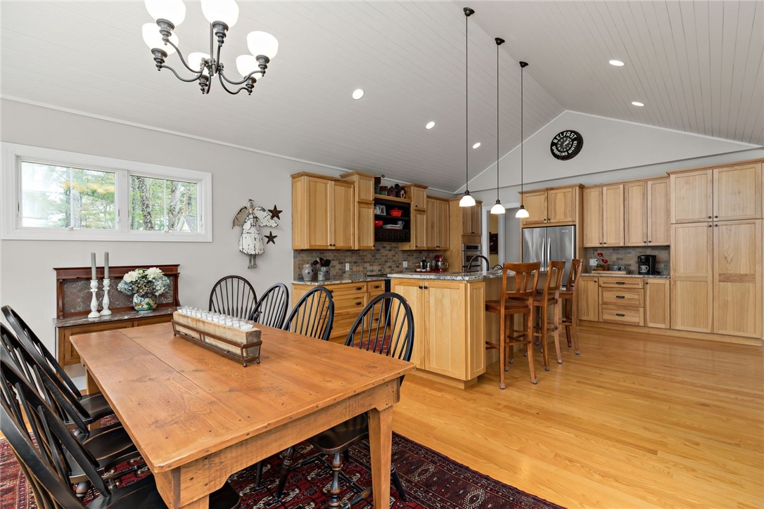 77 Raymonds Point Road Coventry, RI 02816 - Photo 28 of 50 View into the dining room and kitchen from the threshold of the French doors leading out to the back deck.