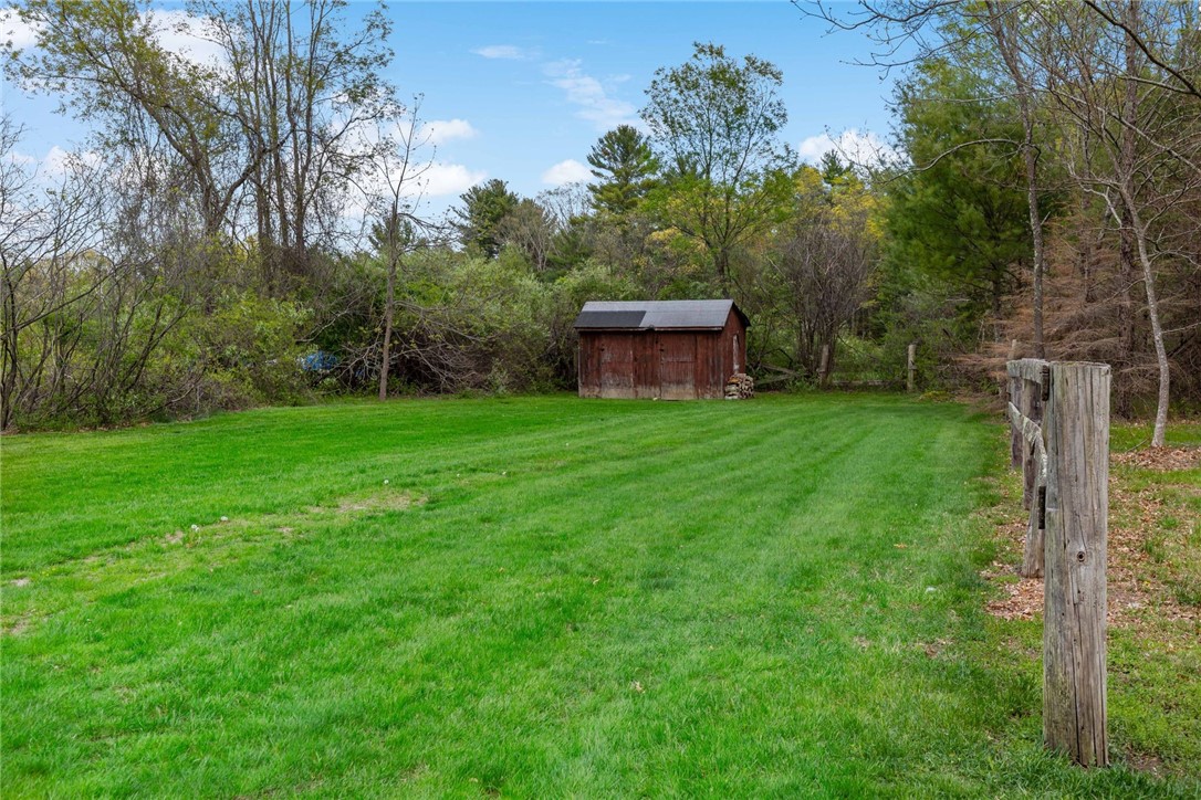 77 Raymonds Point Road Coventry, RI 02816 - Photo 50 of 50 Field/corral and wood shed. Some work would be necessary to prepare corral for horses.