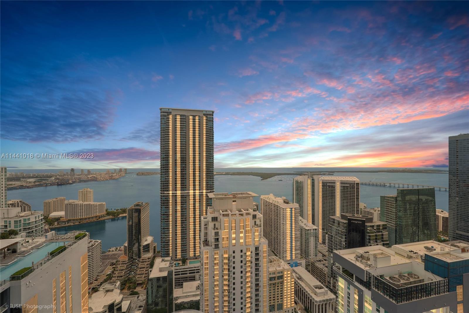 1000 Brickell Plaza, Unit PH5802 Miami, FL 33131 - Photo 1 of 13 a view of a balcony with couches chairs and wooden floor
