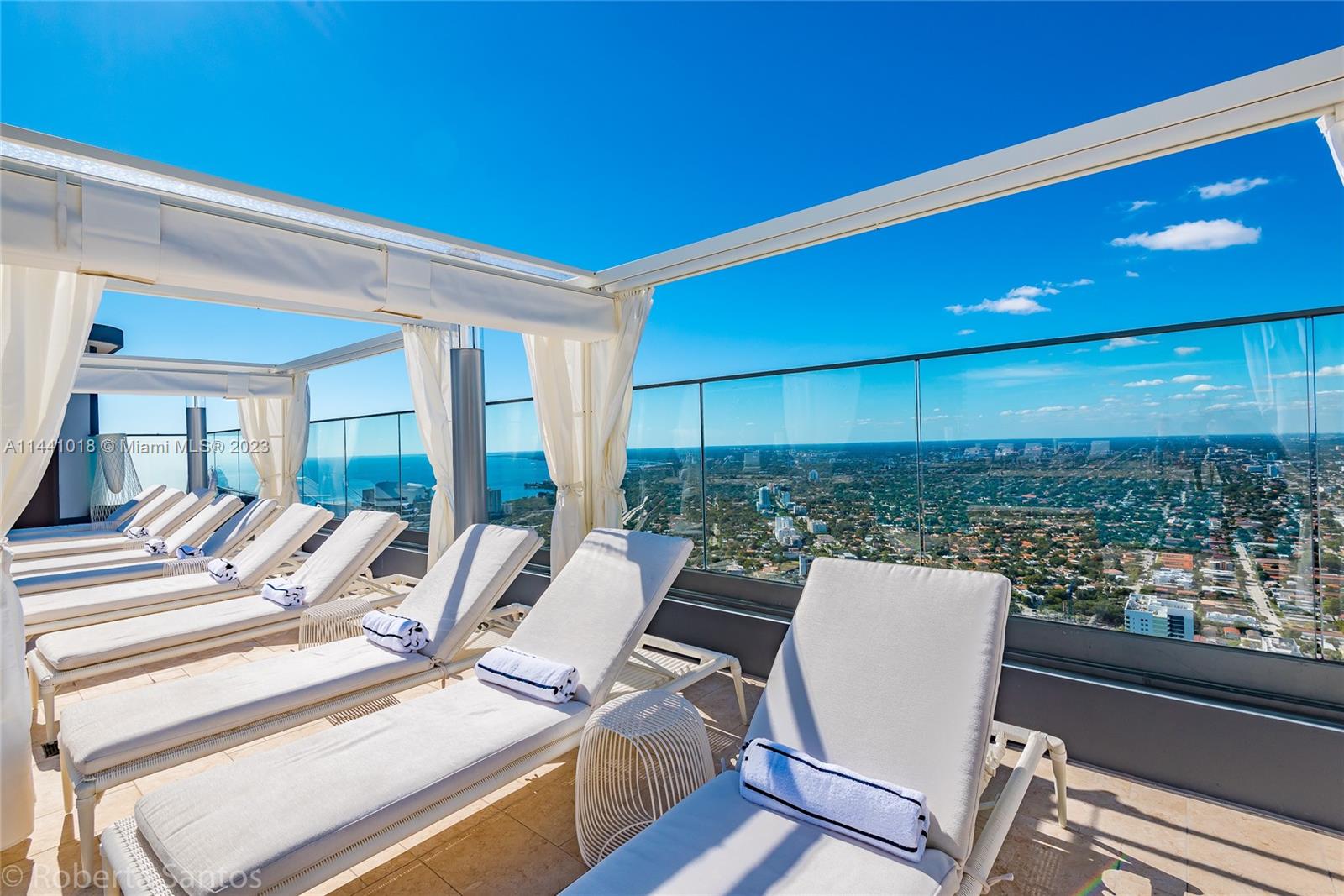 1000 Brickell Plaza, Unit PH5802 Miami, FL 33131 - Photo 13 of 13 a view of a patio with a table and chairs
