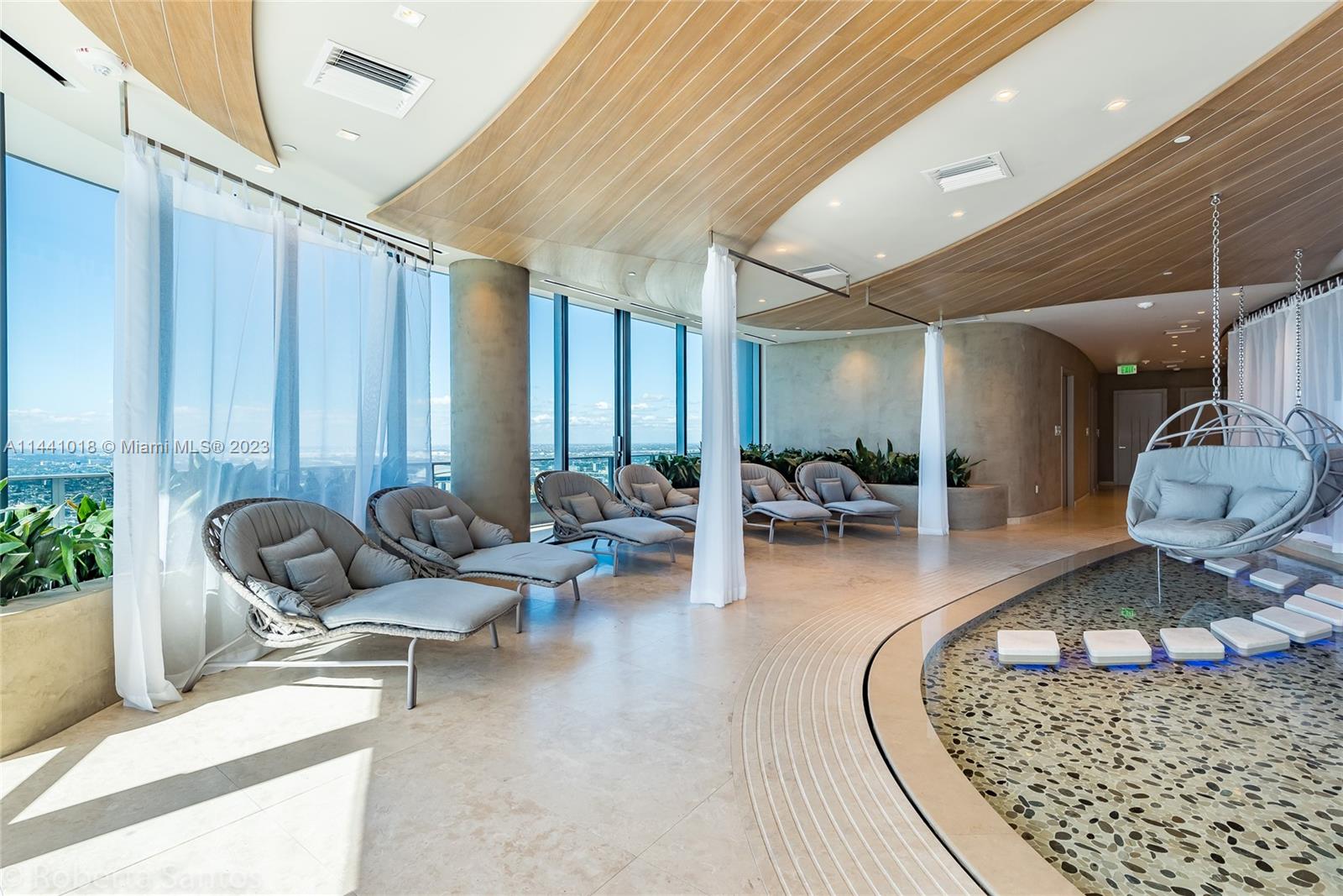 1000 Brickell Plaza, Unit PH5802 Miami, FL 33131 - Photo 8 of 13 a living room with furniture and a large window