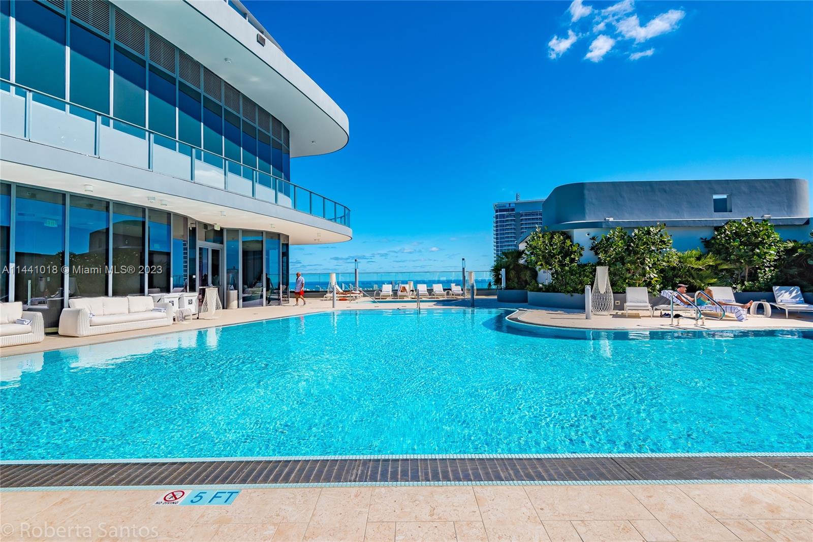 1000 Brickell Plaza, Unit PH5802 Miami, FL 33131 - Photo 10 of 13 a view of swimming pool with outdoor seating and a garden