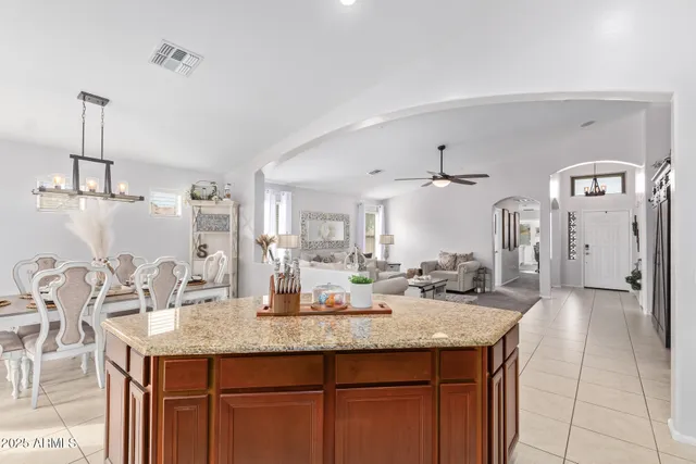 a kitchen with center island table and chairs