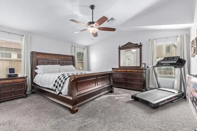 a bedroom with a bed and cabinets