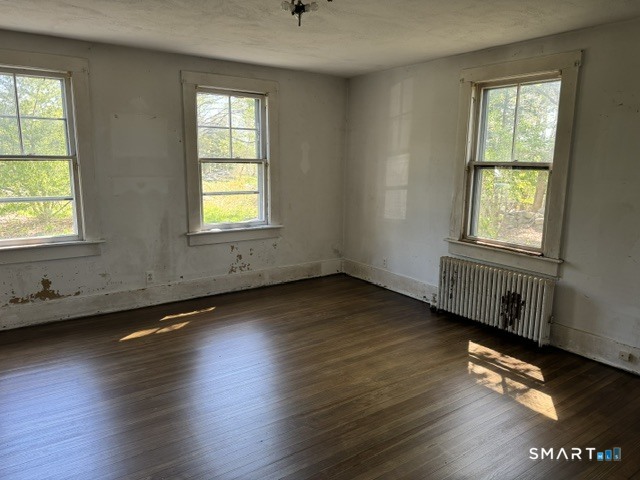 408 Huntington Road Scotland, CT 06264 - Photo 6 of 10 a view of an empty room with wooden floor and a window