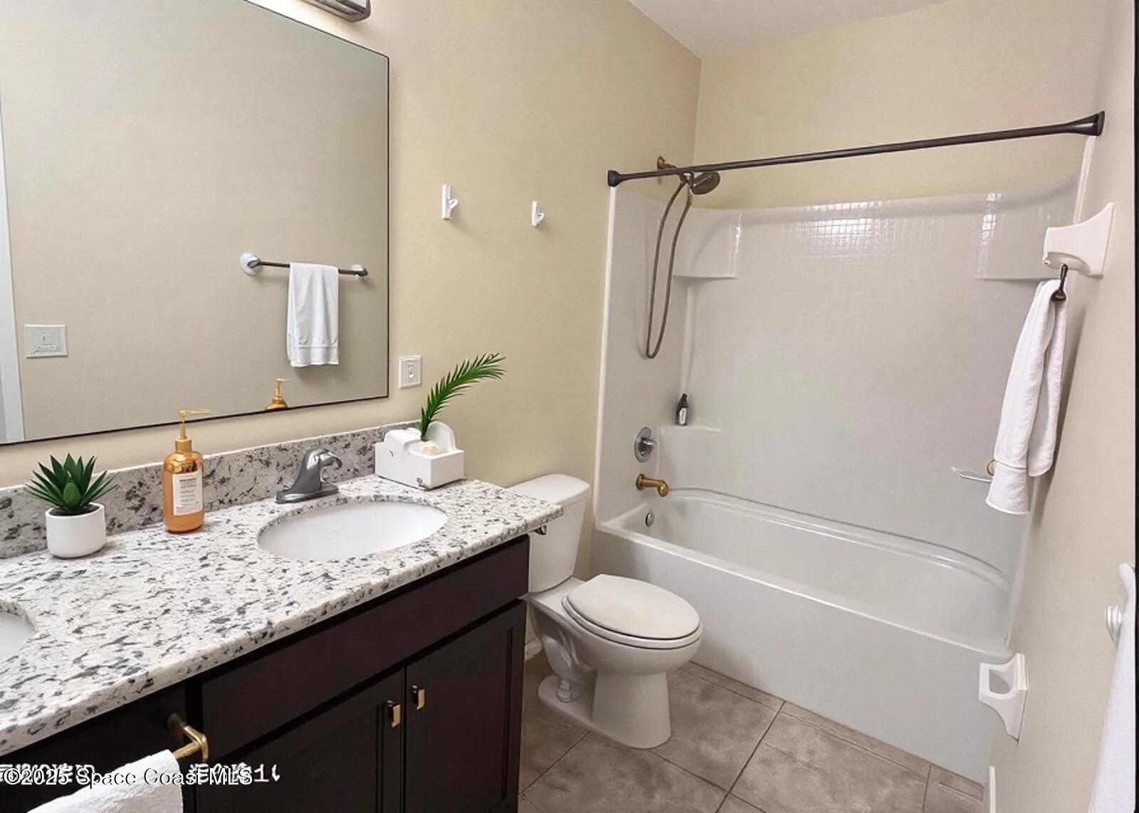 1877 Attilburgh Boulevard West Melbourne, FL 32904 - Photo 14 of 19 a bathroom with a granite countertop sink toilet and shower
