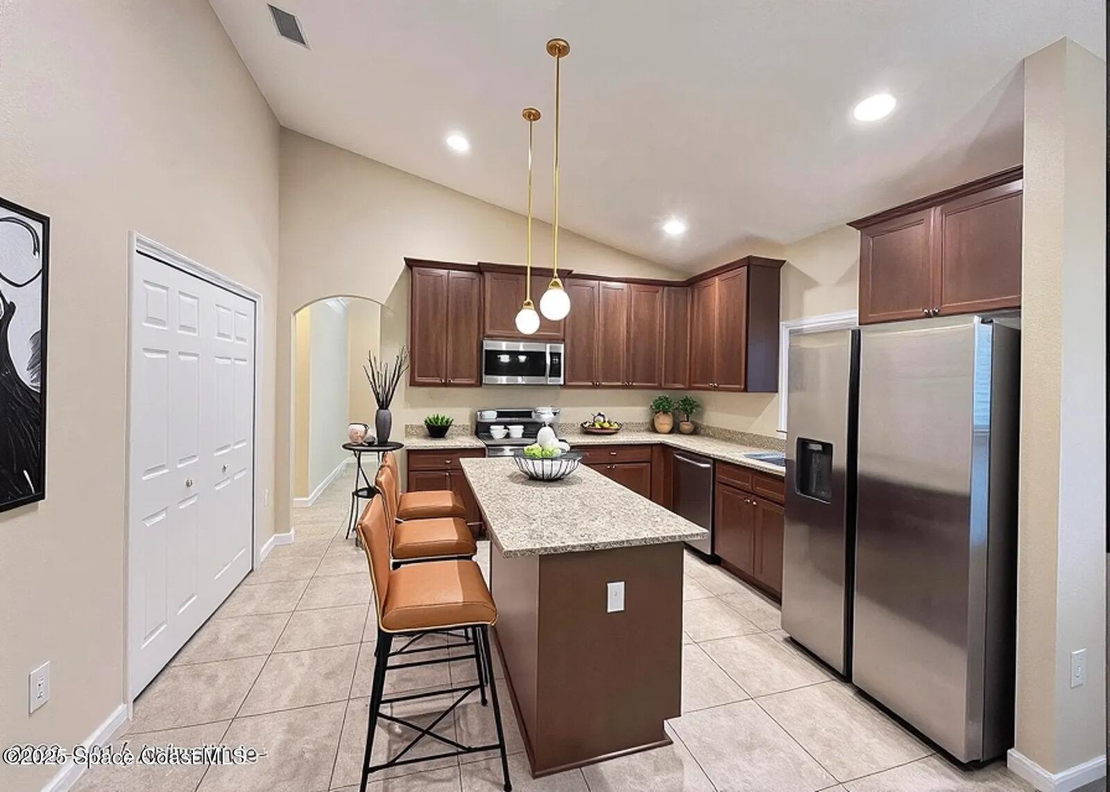 1877 Attilburgh Boulevard West Melbourne, FL 32904 - Photo 8 of 19 a kitchen with granite countertop a refrigerator a sink dishwasher and a stove with wooden floor