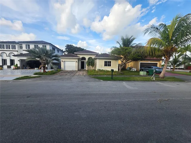 a large kitchen with stainless steel appliances and a counter top space