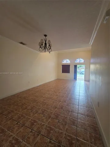 a view of a livingroom with a furniture wooden floor and chandelier