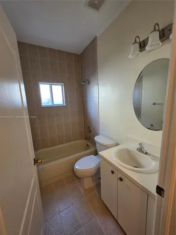 a white toilet sitting next to a shower