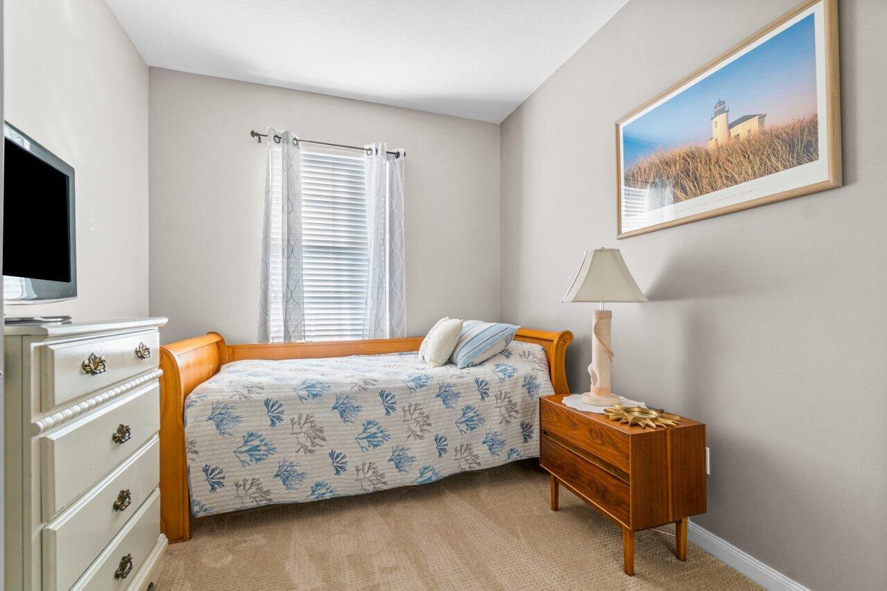 107 Andover Drive Jupiter, FL 33458 - Photo 16 of 26 a bedroom with a bed and a flat screen tv