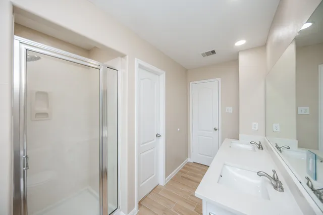 a bathroom with a sink and shower