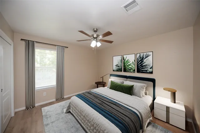 a bedroom with a large bed and a window