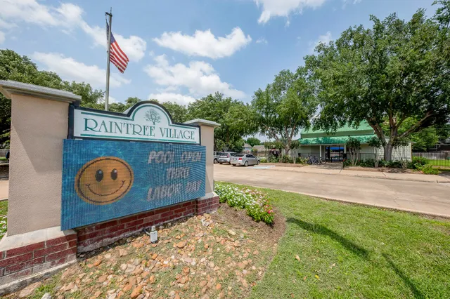 a view of outdoor space with sign board and wooden fence
