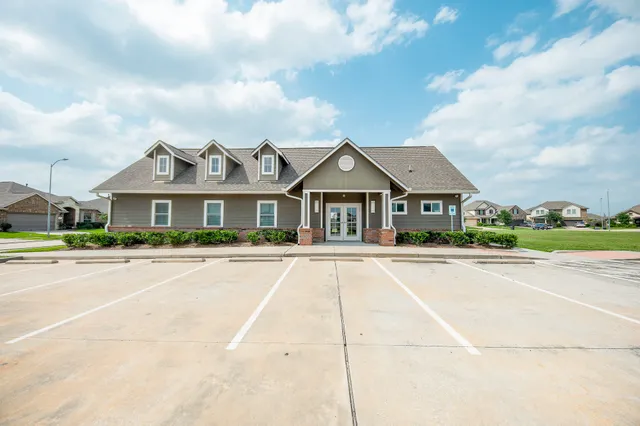 a front view of houses with yard