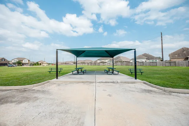 a view of a street with a big yard and palm trees