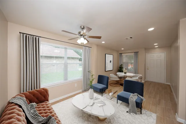 a living room with furniture and a large window