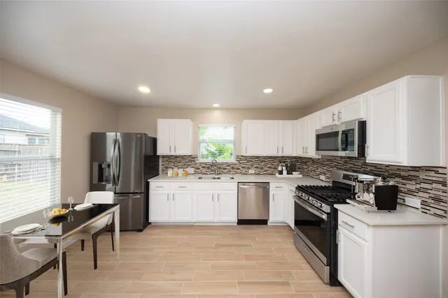 a kitchen with a stove a sink and a refrigerator