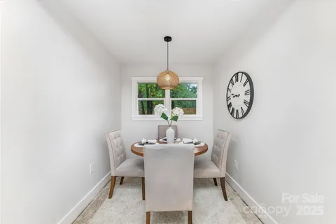 a dining room with a window and a chandelier