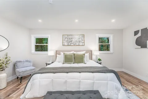 a bedroom with a large bed and a window