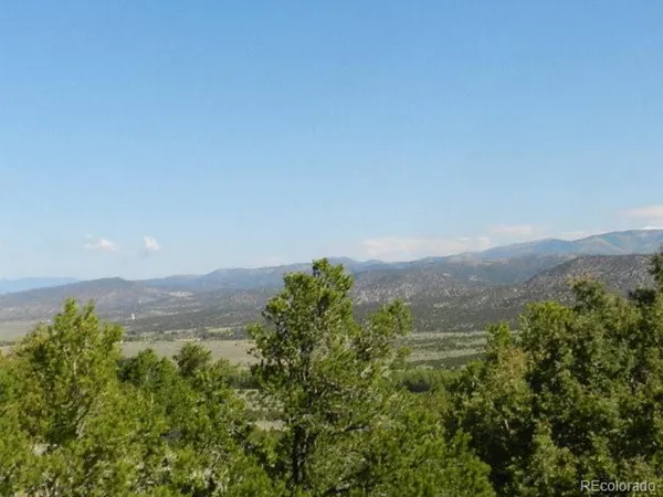 an aerial view of mountain with trees around
